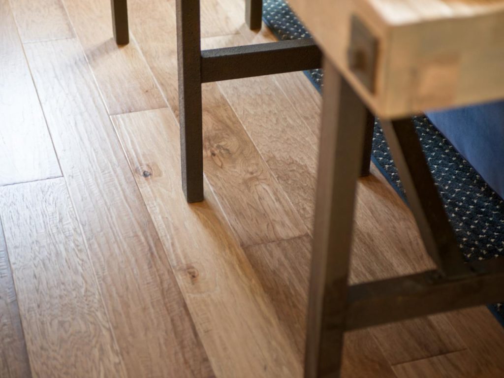 Hardwood floor with natural grain and knot variation in finished planks