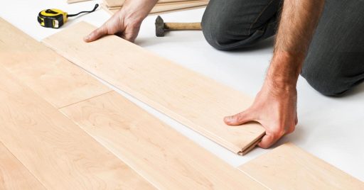 Hardwood floor plank selection during installation showing board appearance differences