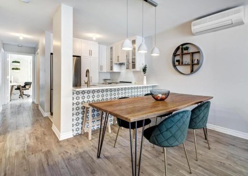 Wide plank hardwood floor in a modern kitchen and dining area showing a clean open visual flow