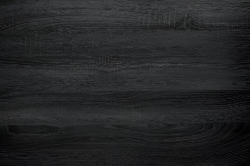Black wood stain finish close up showing a deep dramatic tone and visible grain beneath the dark surface