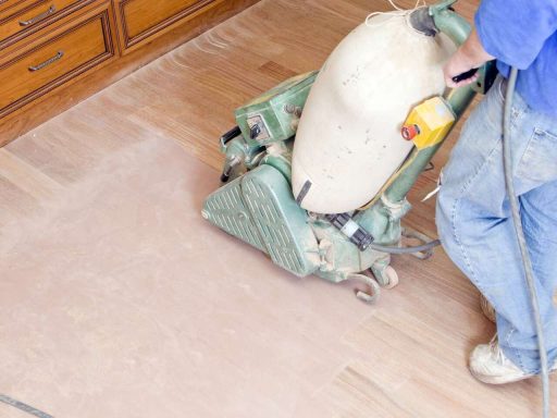 Hardwood floor sanding during restoration to remove old finish and prepare the surface for refinishing