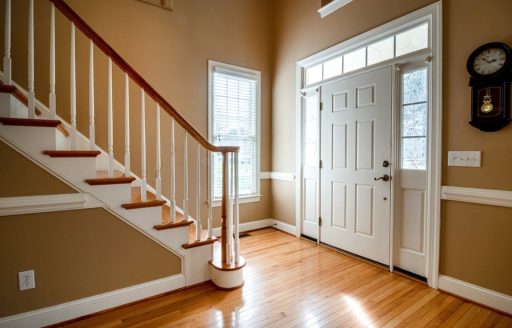 Hardwood floor in an entryway after buff and coat restoration showing renewed shine and a refreshed finish