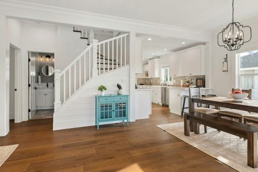 Wide plank hardwood floor in an open traditional home showing broader boards and a calmer visual flow