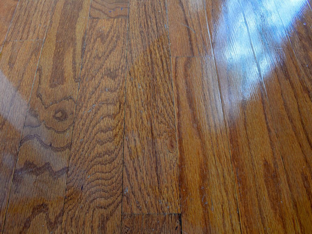 Hardwood floor boards with visible gaps showing the kind of movement and separation that can contribute to squeaks