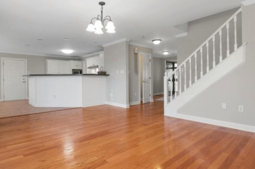 Hardwood floor in open living space showing a smooth continuous surface across a larger layout