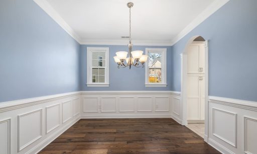 Dark stained hardwood floor in dining room showing a deeper tone and stronger contrast against light walls