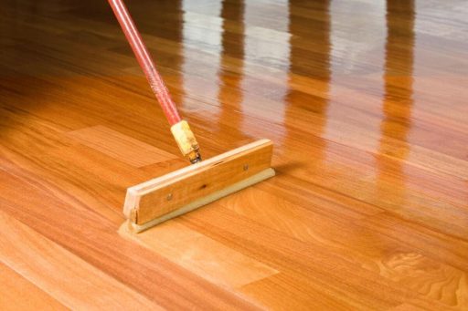 Applying hardwood floor sealant topcoat to build a protective wear layer after refinishing