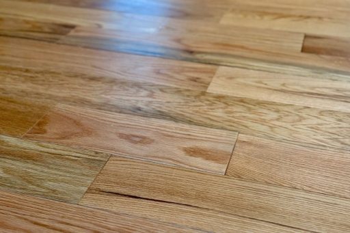 Cabin grade hardwood flooring with natural color variation and visible character marks