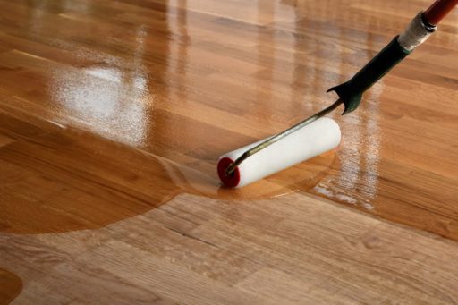 Applying polyurethane finish to a refinished hardwood floor with a roller