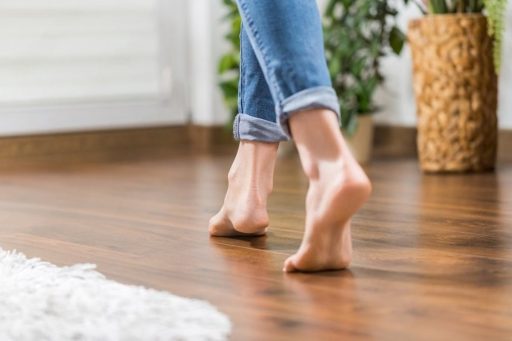 Barefoot traffic on hardwood floor showing a simple residential moment connected to comfort and floor condition