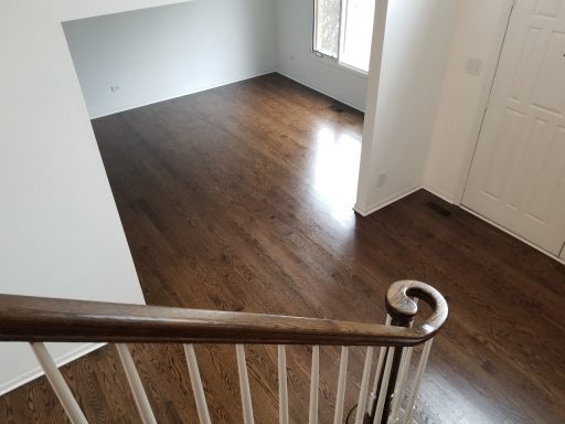 Dark stained hardwood floor in a living space after refinishing