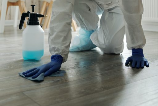 Deep cleaning hardwood floor with a cleaning solution and cloth