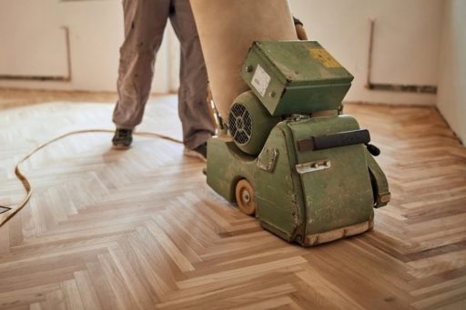 Hardwood floor surface preparation with sander showing the kind of base work that supports a smoother more reliable protective finish