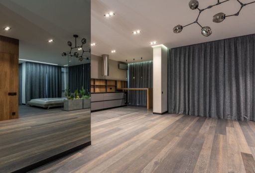 Modern hardwood flooring with dark tones in a contemporary interior space