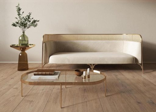 Refinished hardwood floors in a modern living room with natural wood planks, a sofa, and a glass coffee table