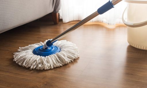 Mopping hardwood floor with a microfiber mop and minimal moisture