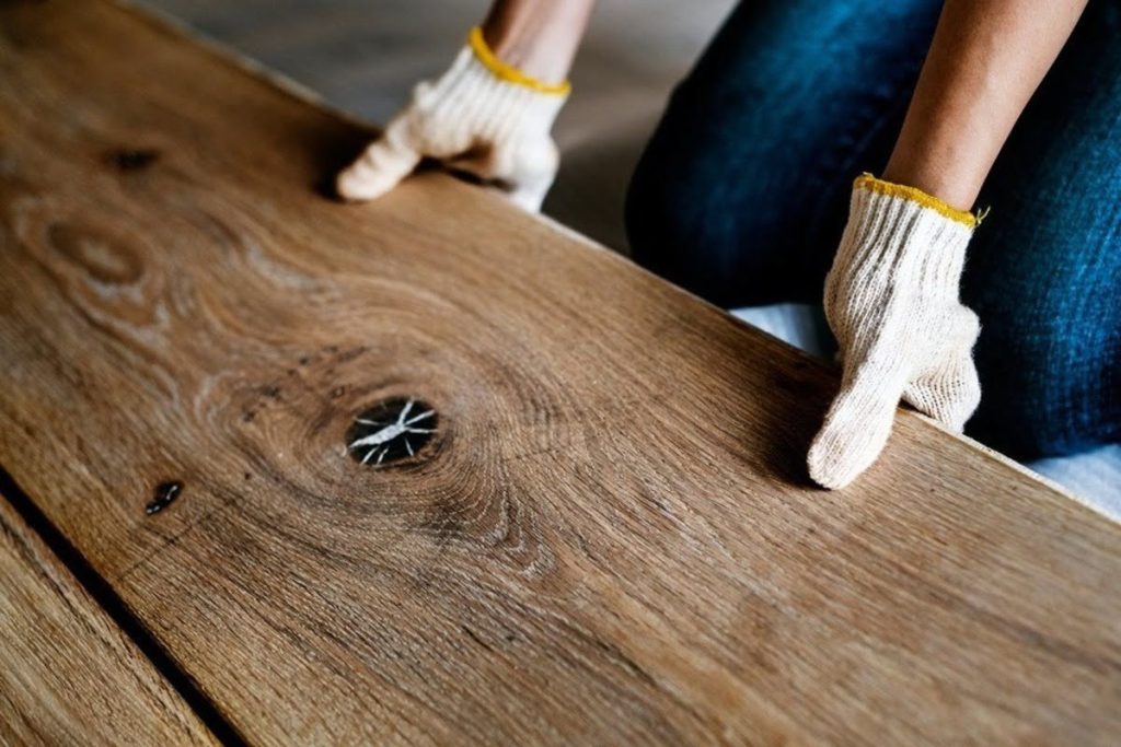 Wide solid hardwood plank close up showing natural grain knots and the character of a single thicker board
