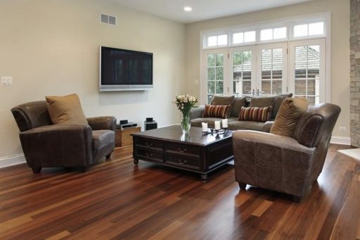 Hardwood floor in living room with smooth finish, warm wood tones, and natural light